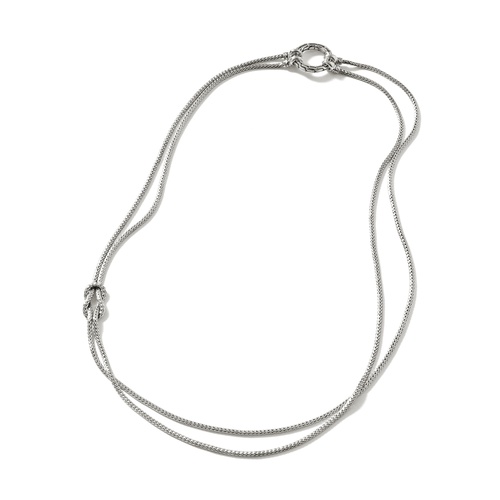 White gold double-chain necklace with a circular clasp and ornamental knot detail, laid out on a plain white background.