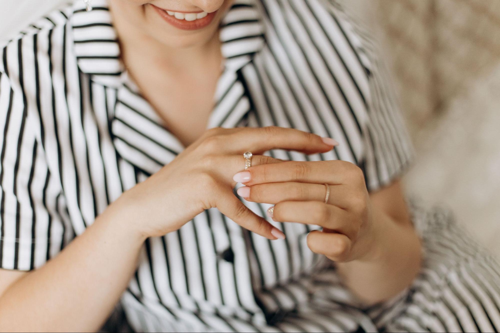 a lady wearing a striped suit and a wedding band