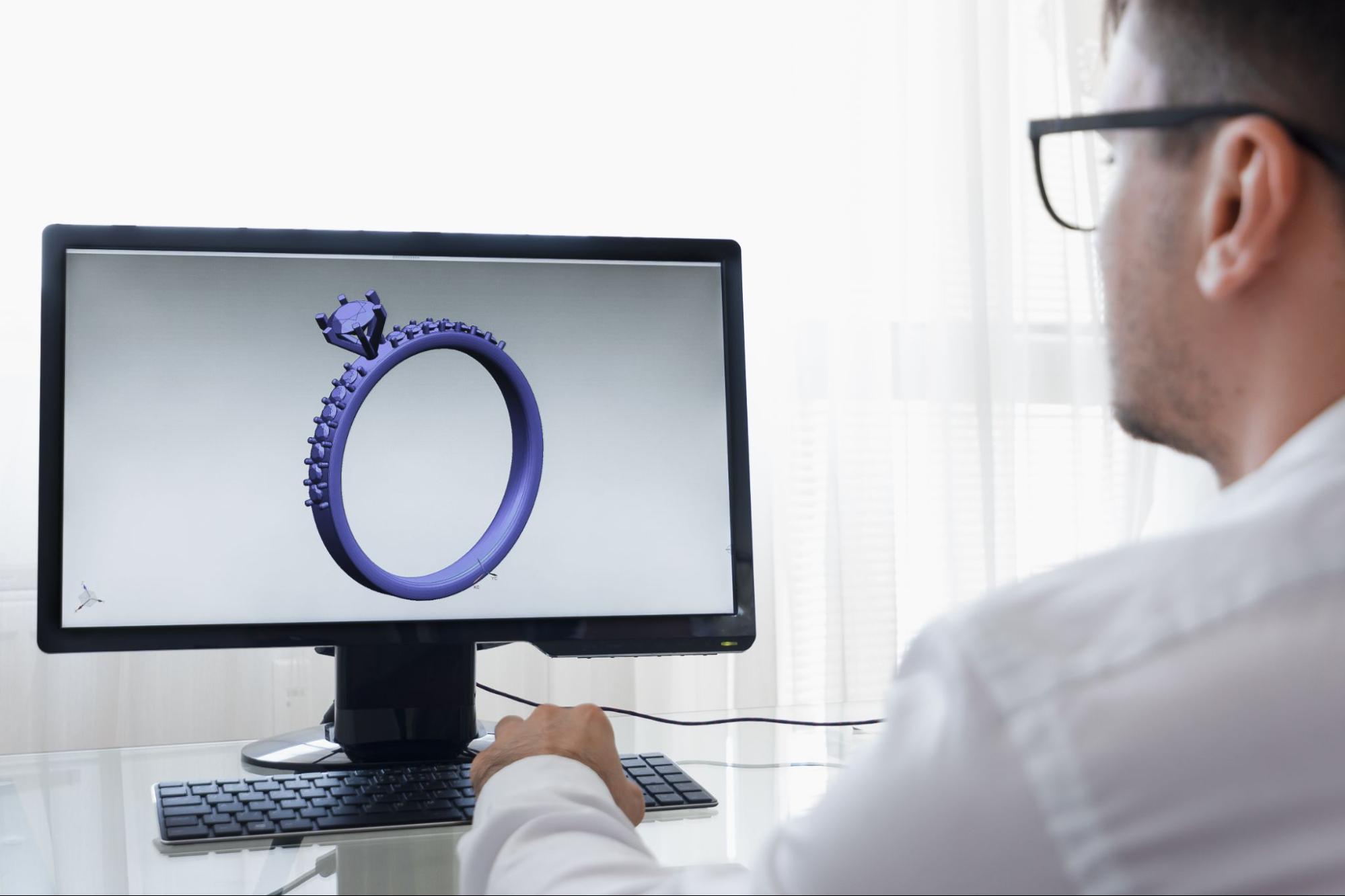 a jeweler at a computer working on a custom design