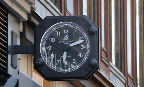 A view of a sign outside of a Breitling showroom, designed to look like one of their distinctive watches.