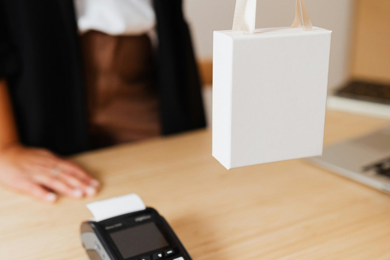 A close-up of a customer receiving their purchase at a locally earned jewelry store.
