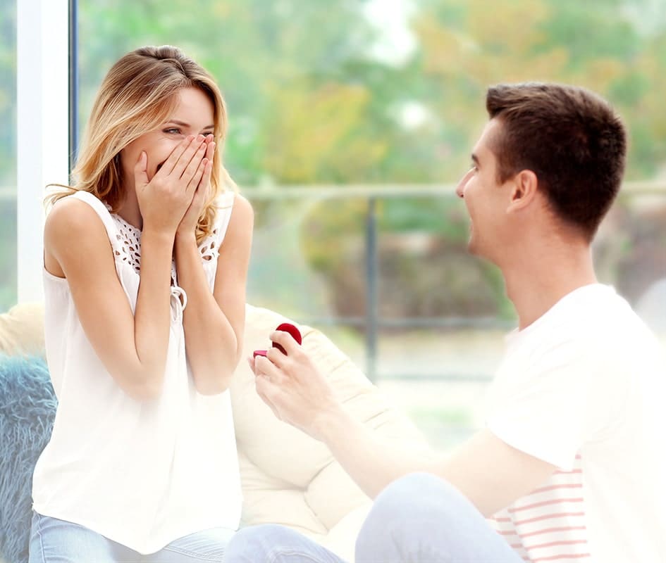 Man proposing to his girlfriend who is overjoyed at the gesture