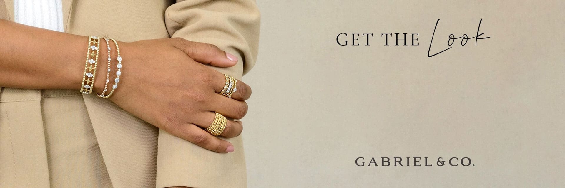 Woman showing off her beautiful gold and pearl bracelets and rings