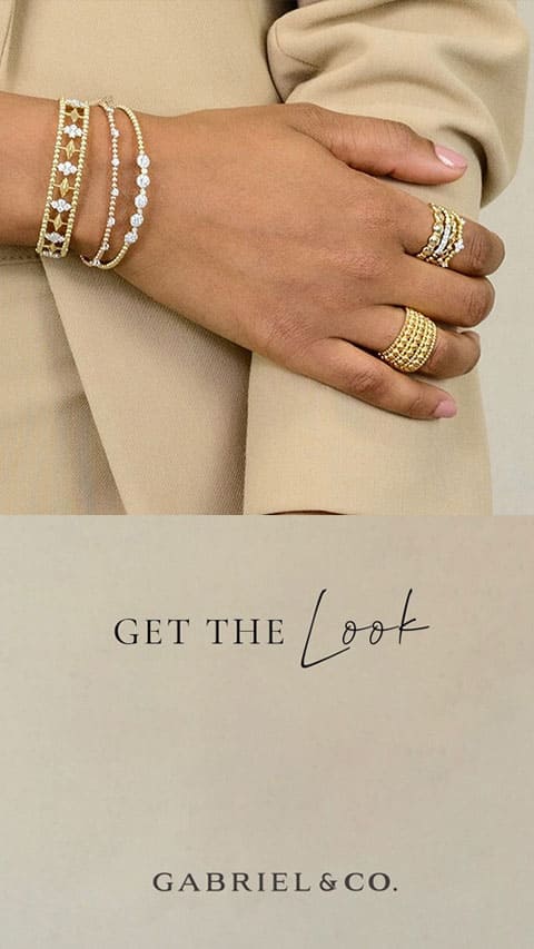Woman showing off her beautiful gold and pearl bracelets and rings
