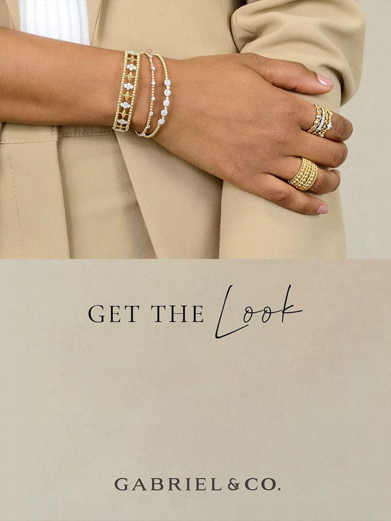 Woman showing off her beautiful gold and pearl bracelets and rings