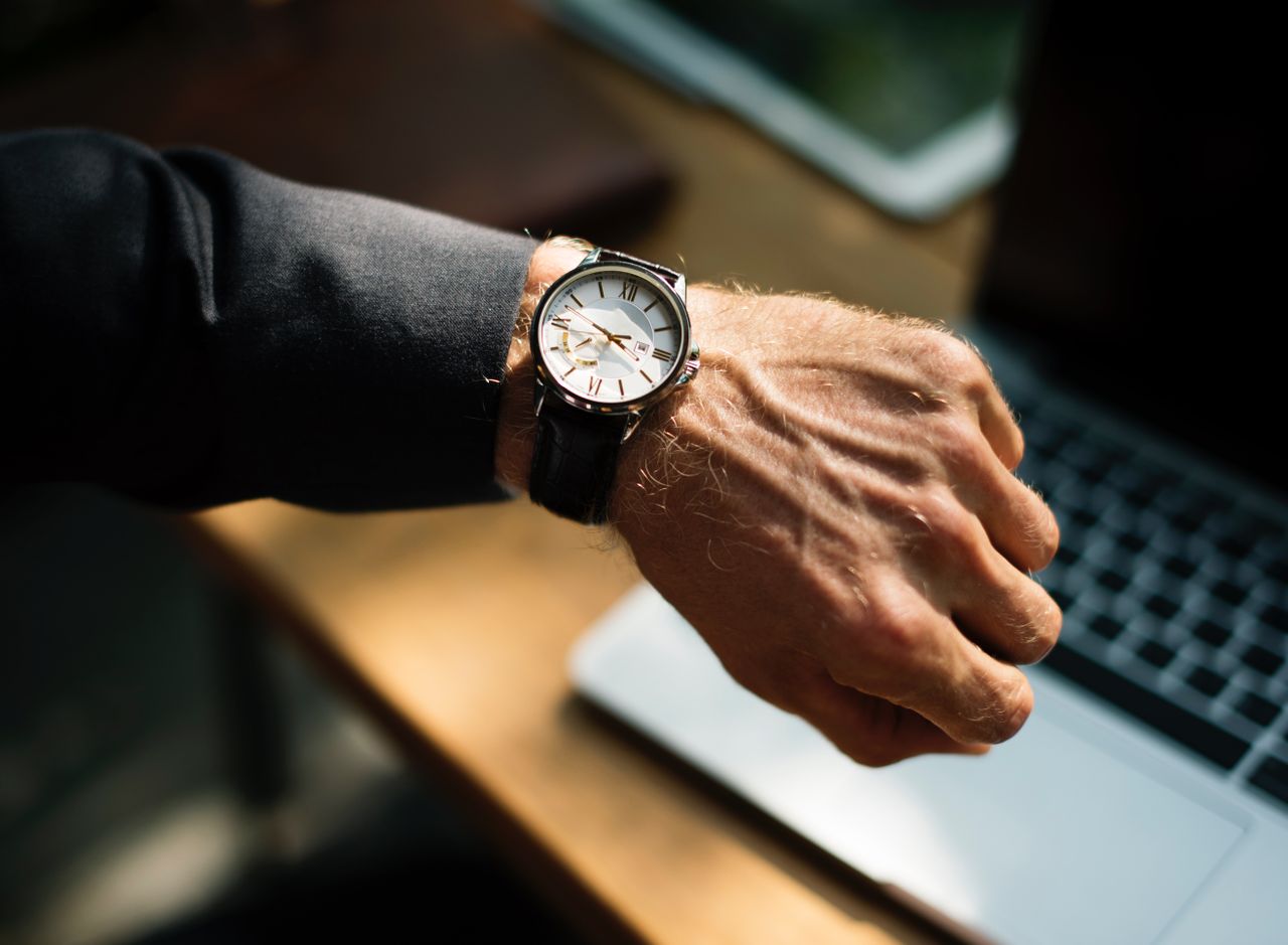 Manly person wearing a watch checks the time