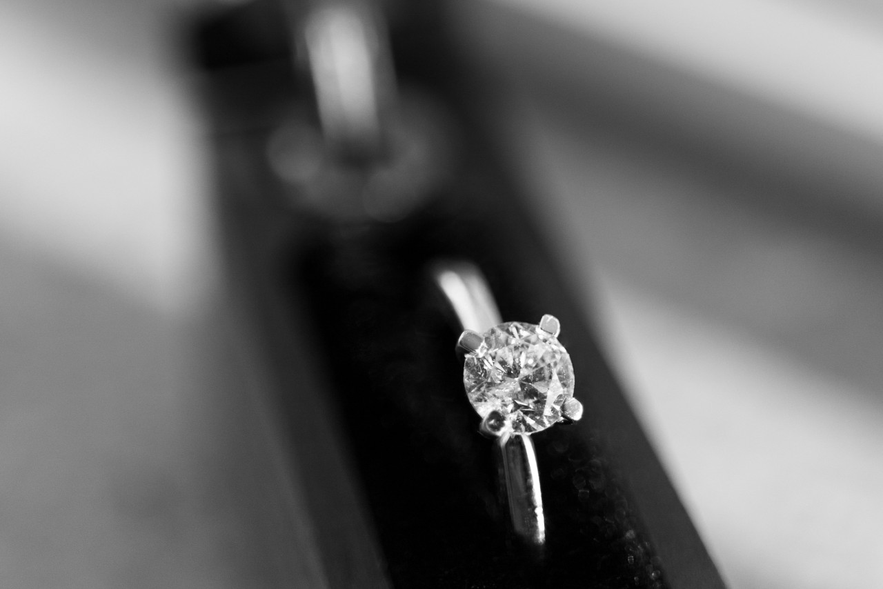 A white gold solitaire diamond engagement ring with round center stone inside a black velvet box A white gold solitaire diamond engagement ring with round center stone inside a black velvet box