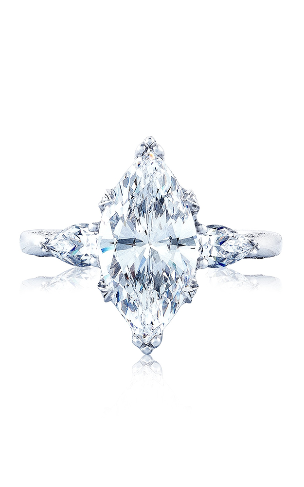 A close up of a white gold marquise cut diamond engagement ring against a white background A close up of a white gold marquise cut diamond engagement ring against a white background