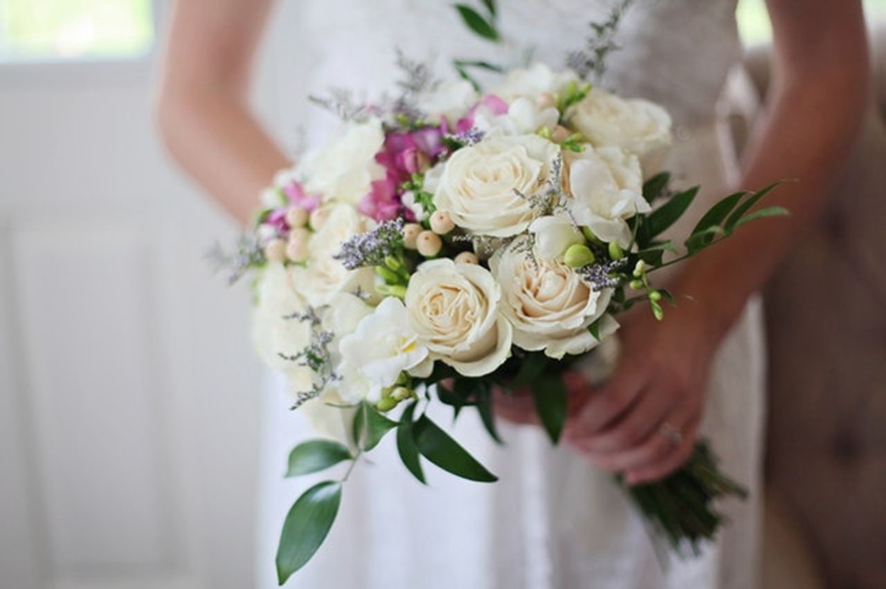 Woman holding bouquet of flowers getting married