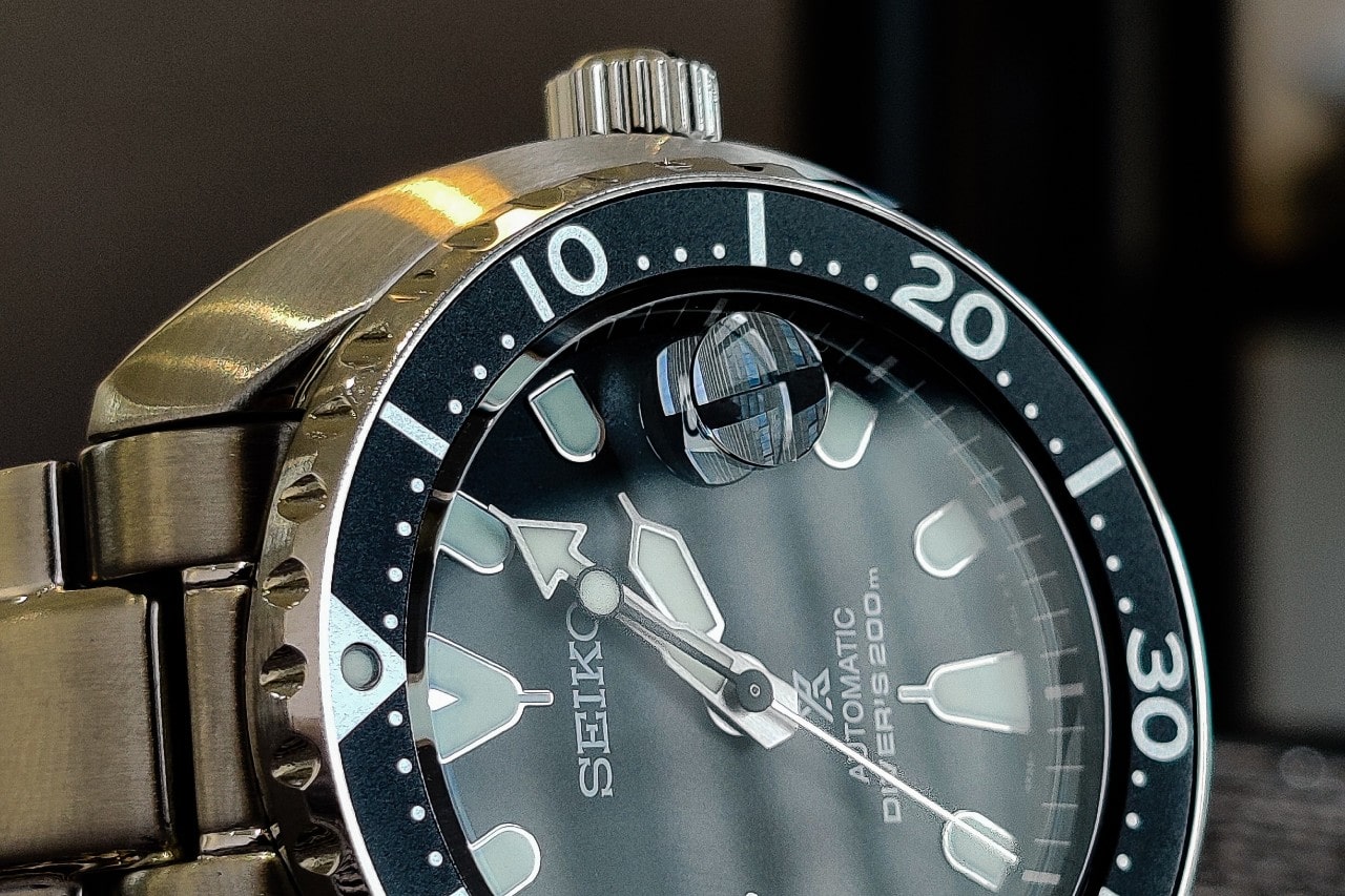 A close-up of a Seiko watch resting on its side. A close-up of a Seiko watch resting on its side.