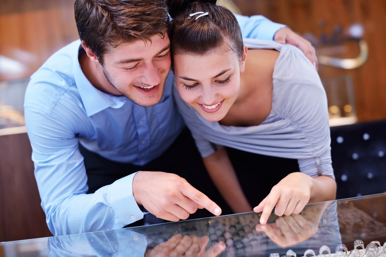 A couple looking at rings together in a jewelry store