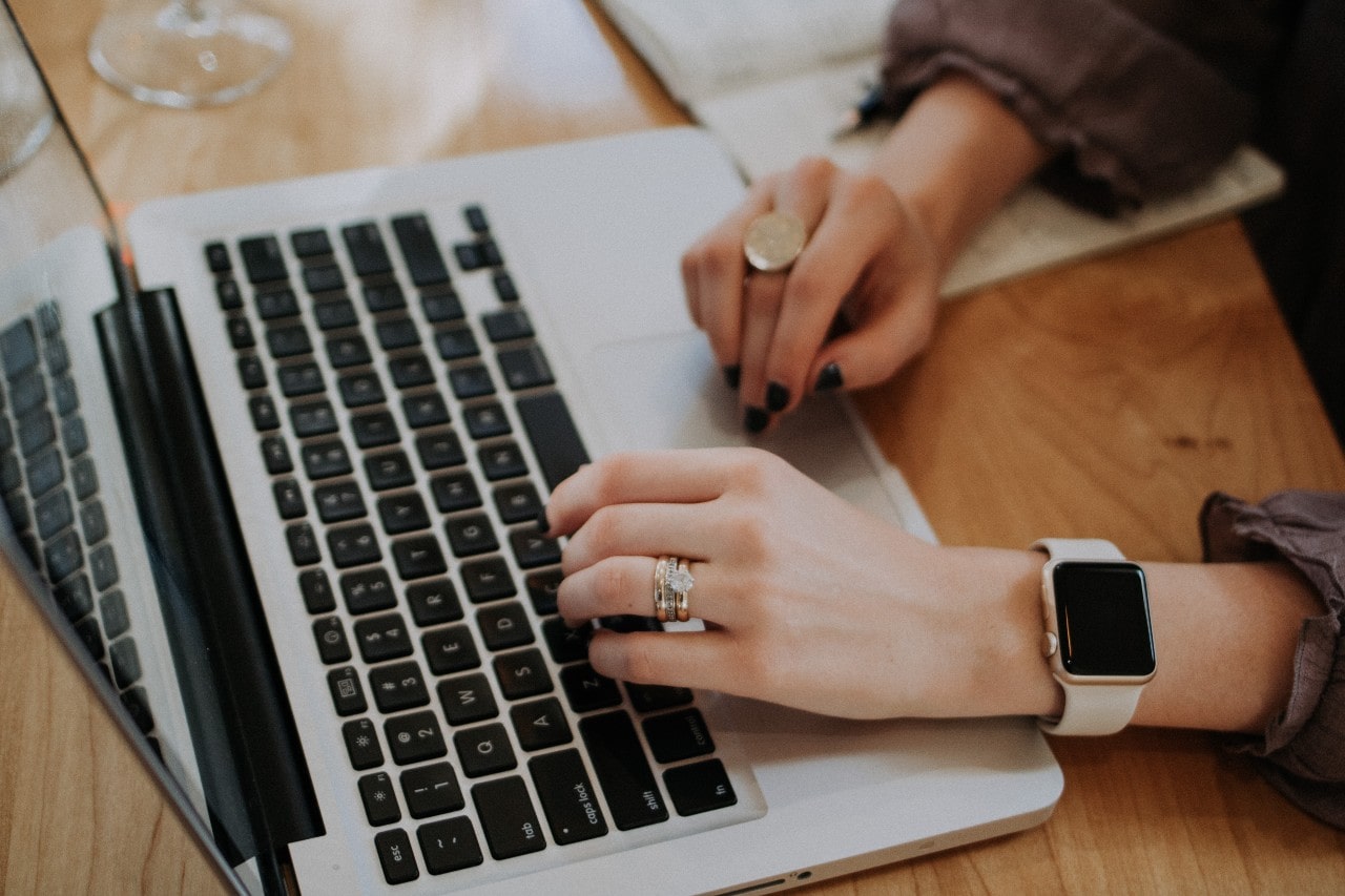 stacked wedding ring with engagement ring using laptop