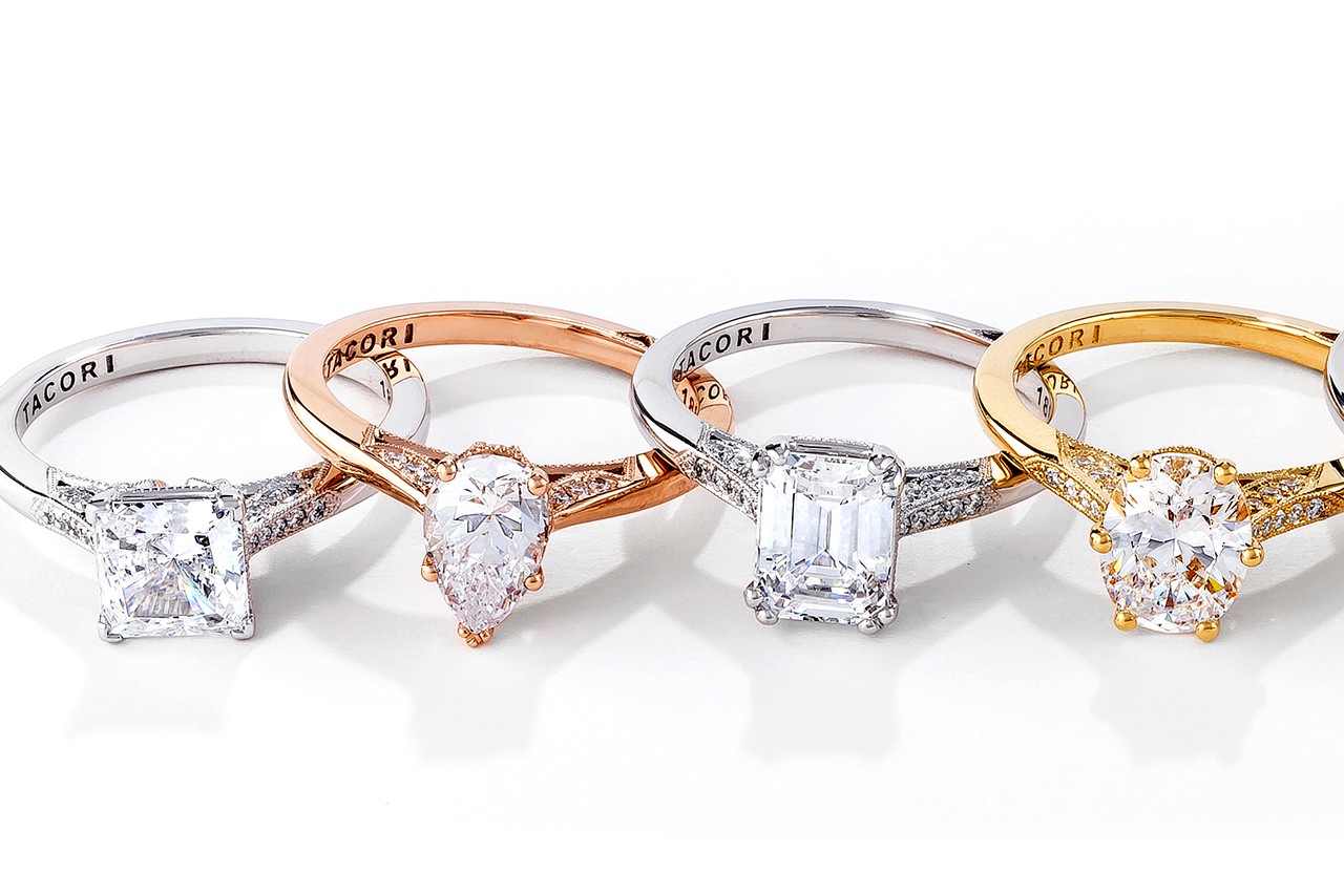 four engagement rings by TACORI in a line, all with different center stones